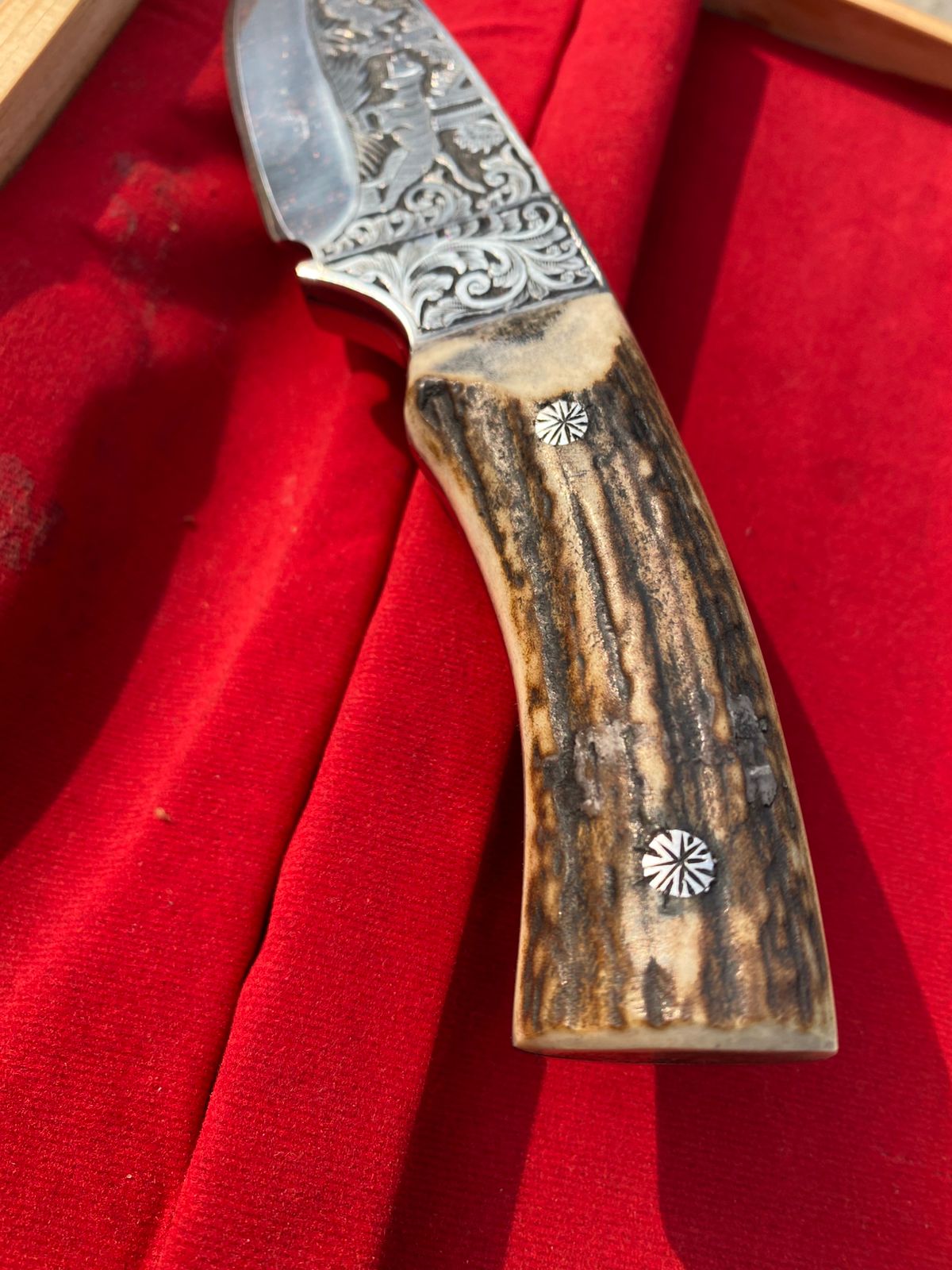 Custom handmade hunting bowie knife with stag horn handle and engraved artistry on blade