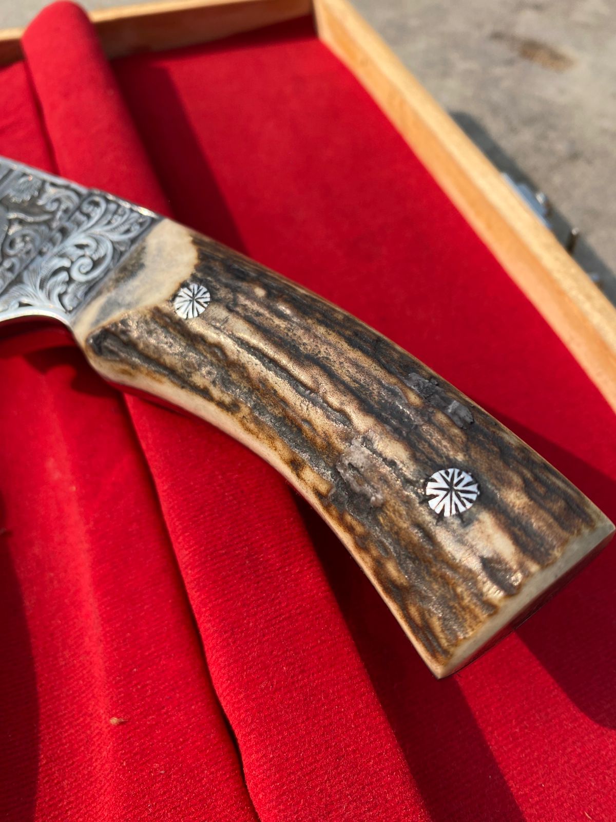 Custom handmade hunting bowie knife with stag horn handle and engraved artistry on blade